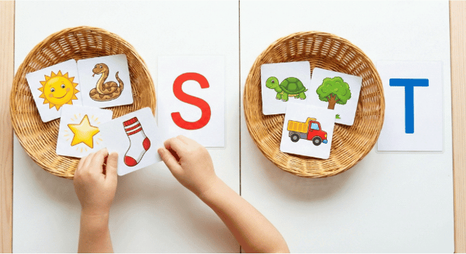 Preschooler sorting picture cards by beginning sound for letter S phonics activity