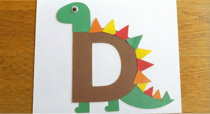 Letter D activities: dinosaur craft using letter D shape with colorful spikes collage
