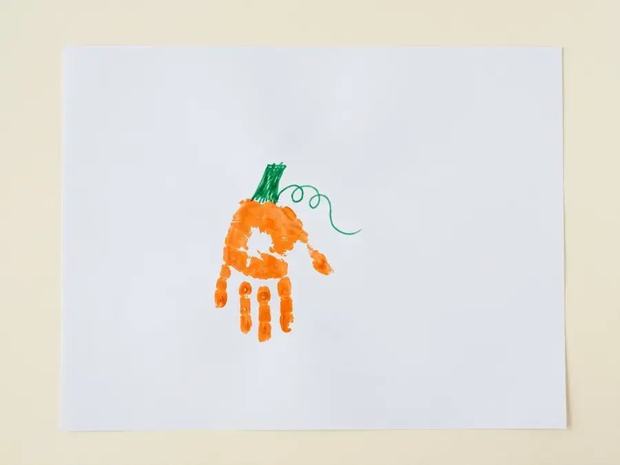 Handprint pumpkin, an easy pumpkin craft for preschoolers ages 3 to 5