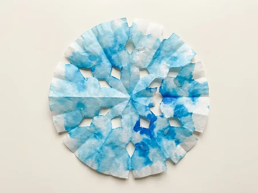 Coffee filter snowflake, an easy January craft for preschoolers ages 3 to 5