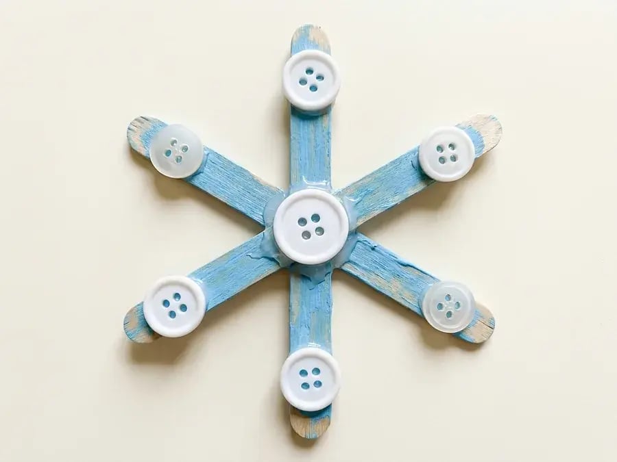 Craft stick button snowflake, an easy January craft for preschoolers ages 3 to 5