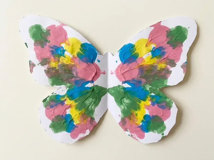 Fold and squish butterfly painting, an easy butterfly craft for preschoolers ages 3 to 5
